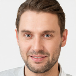 Joyful white young-adult male with short  brown hair and grey eyes