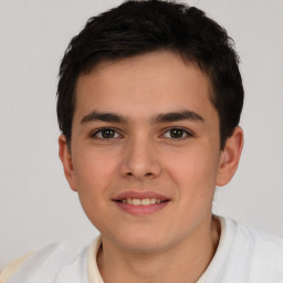 Joyful white child male with short  brown hair and brown eyes