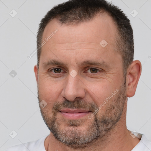 Joyful white adult male with short  brown hair and brown eyes