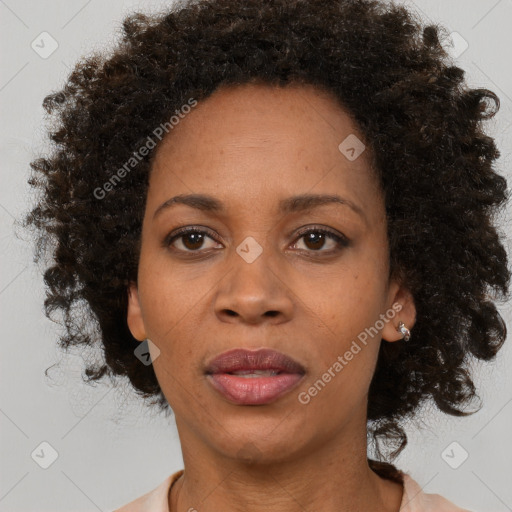 Joyful black adult female with medium  brown hair and brown eyes