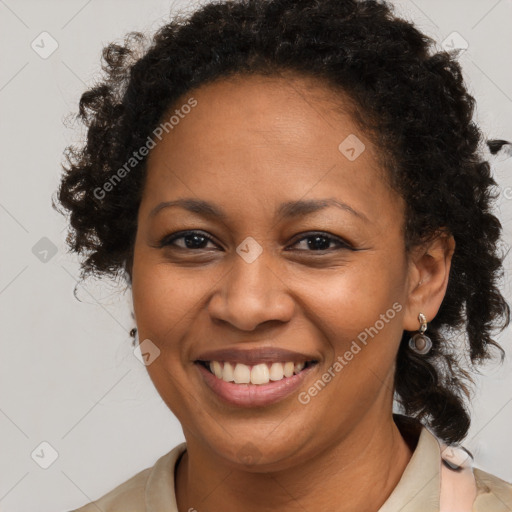 Joyful black adult female with medium  brown hair and brown eyes