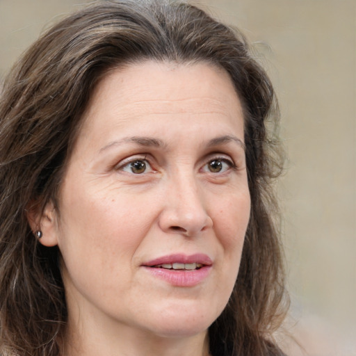 Joyful white adult female with medium  brown hair and grey eyes