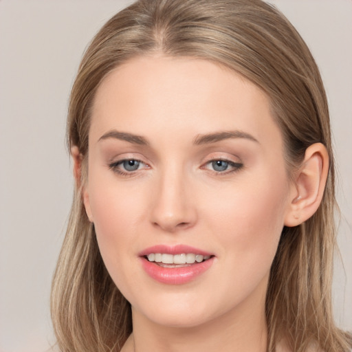 Joyful white young-adult female with long  brown hair and grey eyes