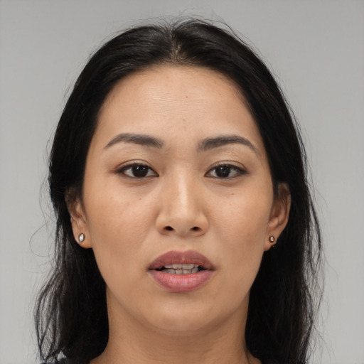 Joyful asian young-adult female with long  black hair and brown eyes
