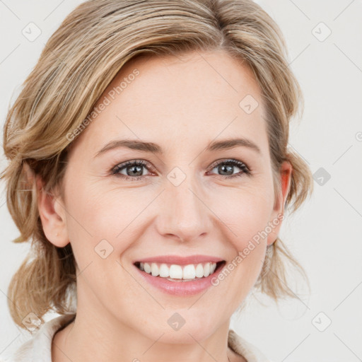 Joyful white young-adult female with medium  brown hair and blue eyes