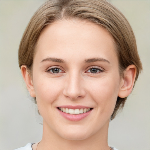 Joyful white young-adult female with medium  brown hair and grey eyes