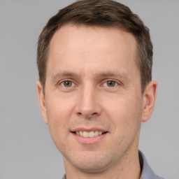 Joyful white adult male with short  brown hair and brown eyes