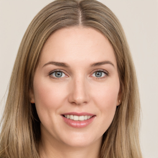 Joyful white young-adult female with long  brown hair and green eyes