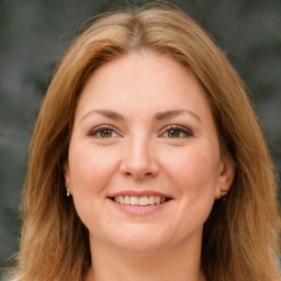 Joyful white young-adult female with long  brown hair and green eyes