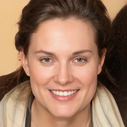 Joyful white adult female with long  brown hair and brown eyes