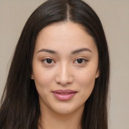 Joyful asian young-adult female with long  brown hair and brown eyes