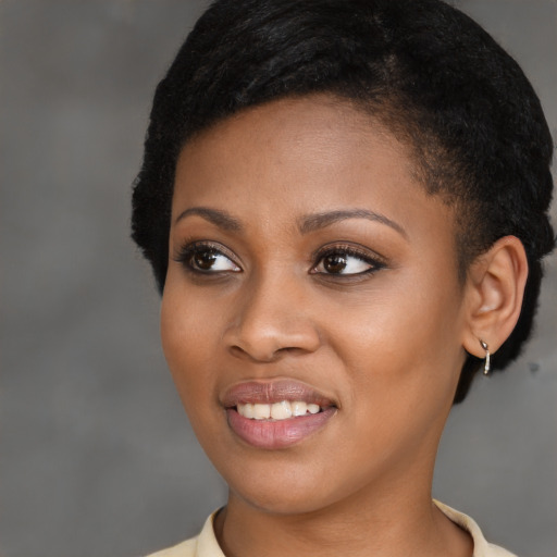 Joyful latino young-adult female with short  black hair and brown eyes