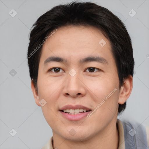 Joyful asian young-adult male with short  brown hair and brown eyes