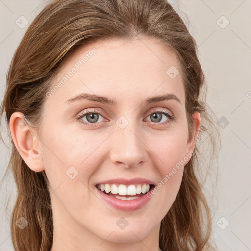 Joyful white young-adult female with long  brown hair and blue eyes