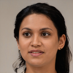 Joyful latino young-adult female with medium  black hair and brown eyes