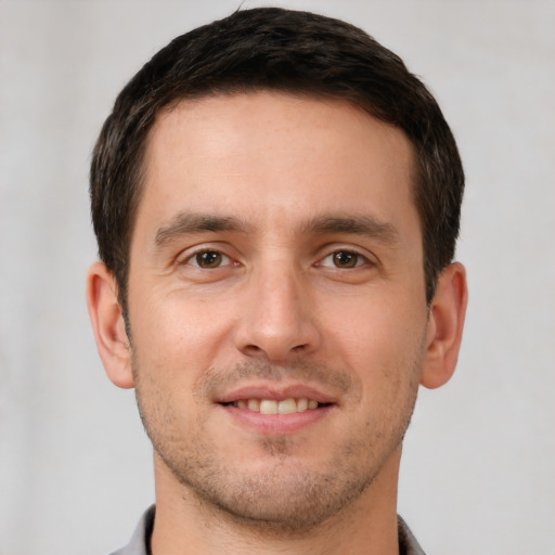 Joyful white young-adult male with short  brown hair and brown eyes