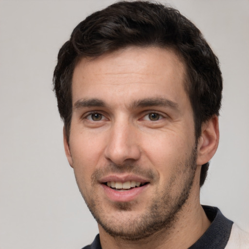 Joyful white young-adult male with short  black hair and brown eyes