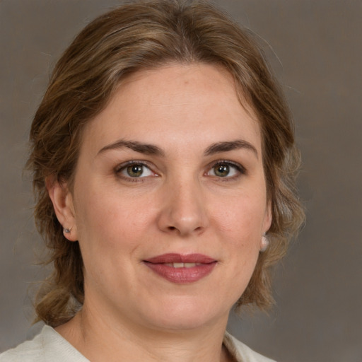 Joyful white young-adult female with medium  brown hair and green eyes