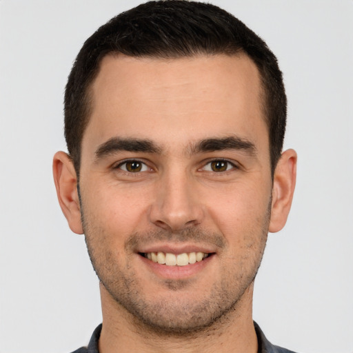 Joyful white young-adult male with short  brown hair and brown eyes