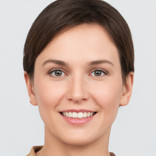 Joyful white young-adult female with short  brown hair and brown eyes