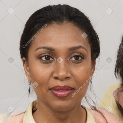 Joyful black adult female with medium  brown hair and brown eyes