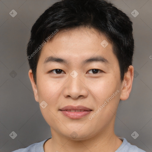 Joyful asian young-adult male with short  brown hair and brown eyes