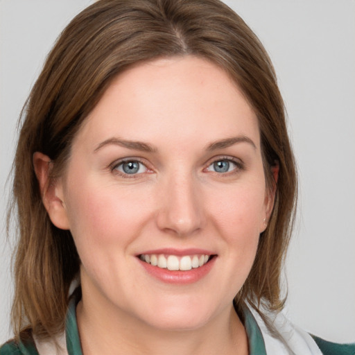 Joyful white young-adult female with medium  brown hair and blue eyes