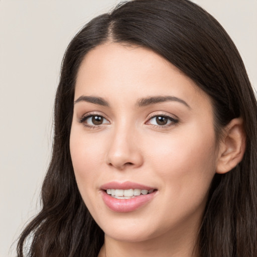 Joyful white young-adult female with long  brown hair and brown eyes