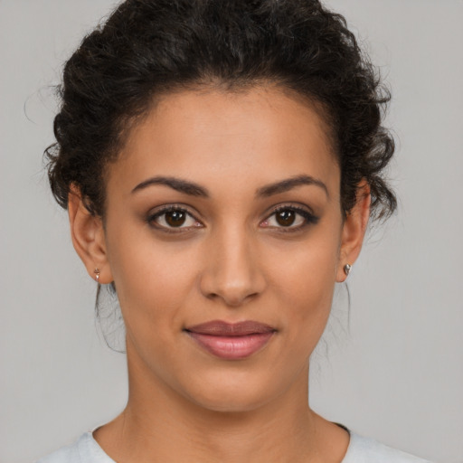 Joyful latino young-adult female with short  brown hair and brown eyes