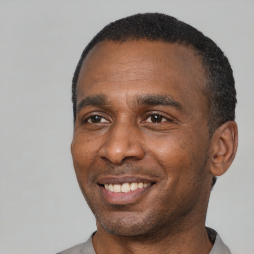 Joyful latino adult male with short  black hair and brown eyes