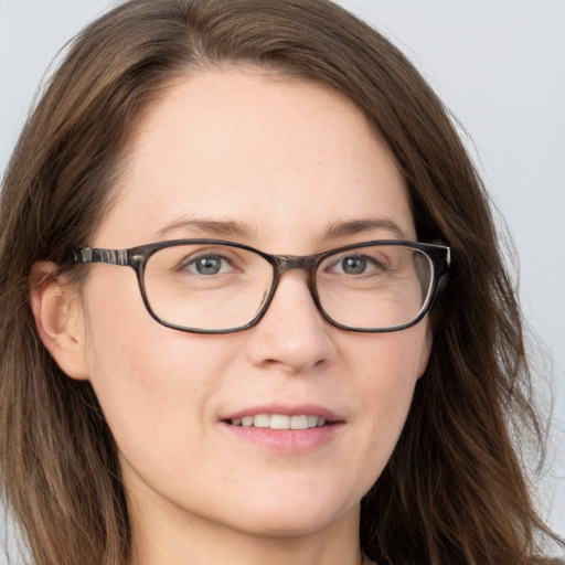 Joyful white adult female with long  brown hair and brown eyes