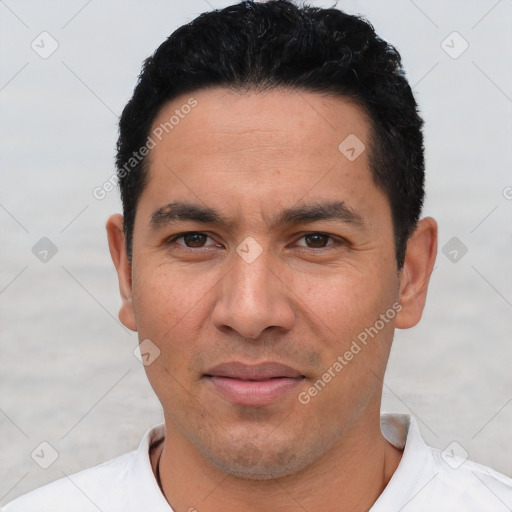 Joyful white young-adult male with short  black hair and brown eyes