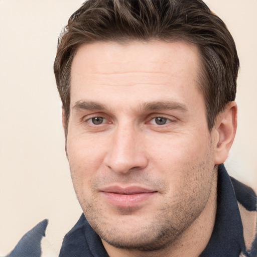 Joyful white young-adult male with short  brown hair and grey eyes