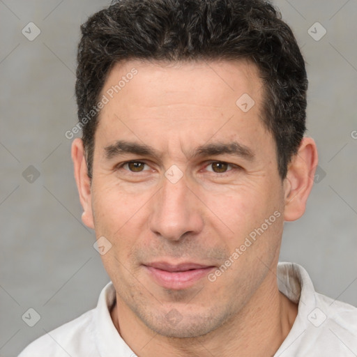 Joyful white adult male with short  brown hair and brown eyes