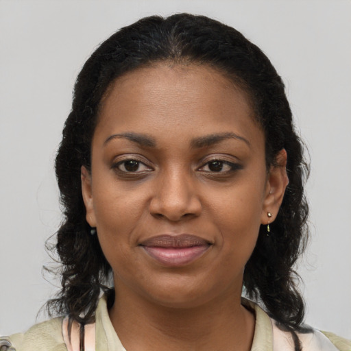 Joyful black young-adult female with medium  brown hair and brown eyes