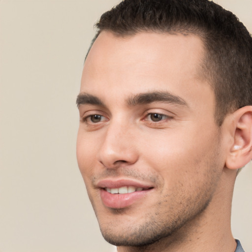 Joyful white young-adult male with short  brown hair and brown eyes