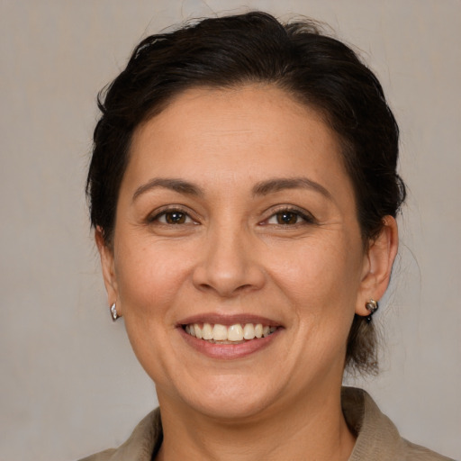 Joyful white adult female with medium  brown hair and brown eyes