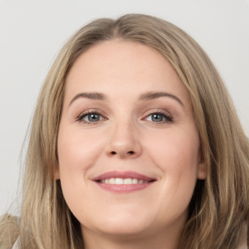 Joyful white young-adult female with long  brown hair and grey eyes