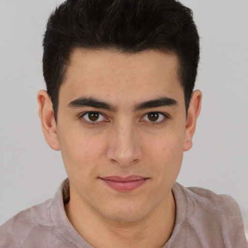Joyful latino young-adult male with short  brown hair and brown eyes