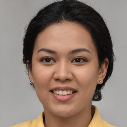 Joyful asian young-adult female with medium  brown hair and brown eyes