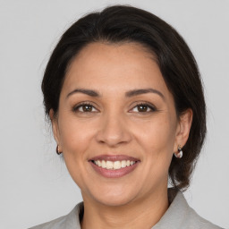 Joyful white adult female with medium  brown hair and brown eyes