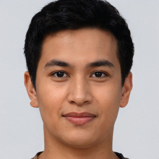 Joyful asian young-adult male with short  black hair and brown eyes