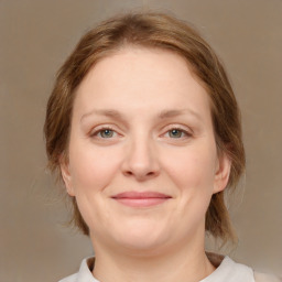 Joyful white adult female with medium  brown hair and brown eyes