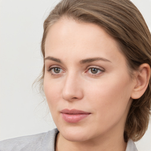 Joyful white young-adult female with medium  brown hair and blue eyes