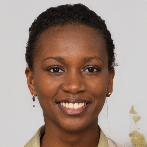 Joyful black young-adult female with short  brown hair and brown eyes