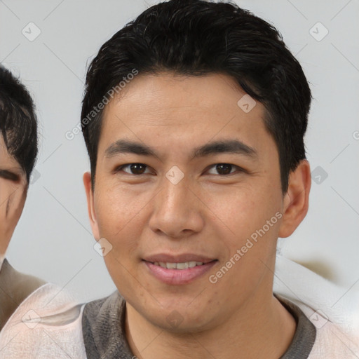 Joyful asian young-adult male with short  brown hair and brown eyes