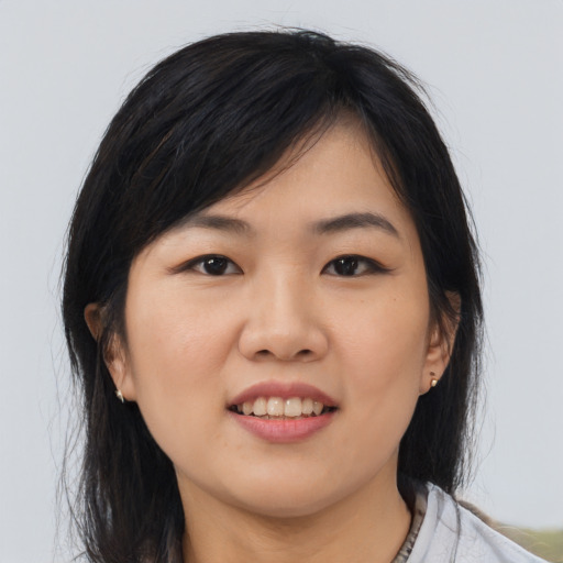 Joyful asian young-adult female with medium  black hair and brown eyes