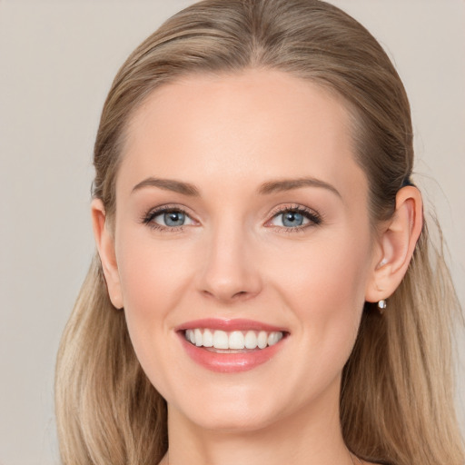 Joyful white young-adult female with long  brown hair and blue eyes