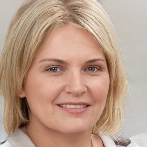 Joyful white young-adult female with medium  blond hair and blue eyes