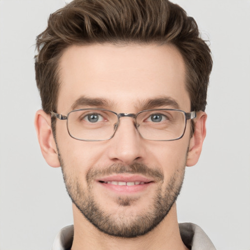 Joyful white young-adult male with short  brown hair and grey eyes